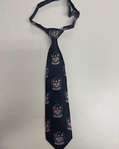 Dark blue patterned necktie on white background.