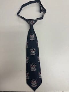 Dark blue patterned necktie on white background.