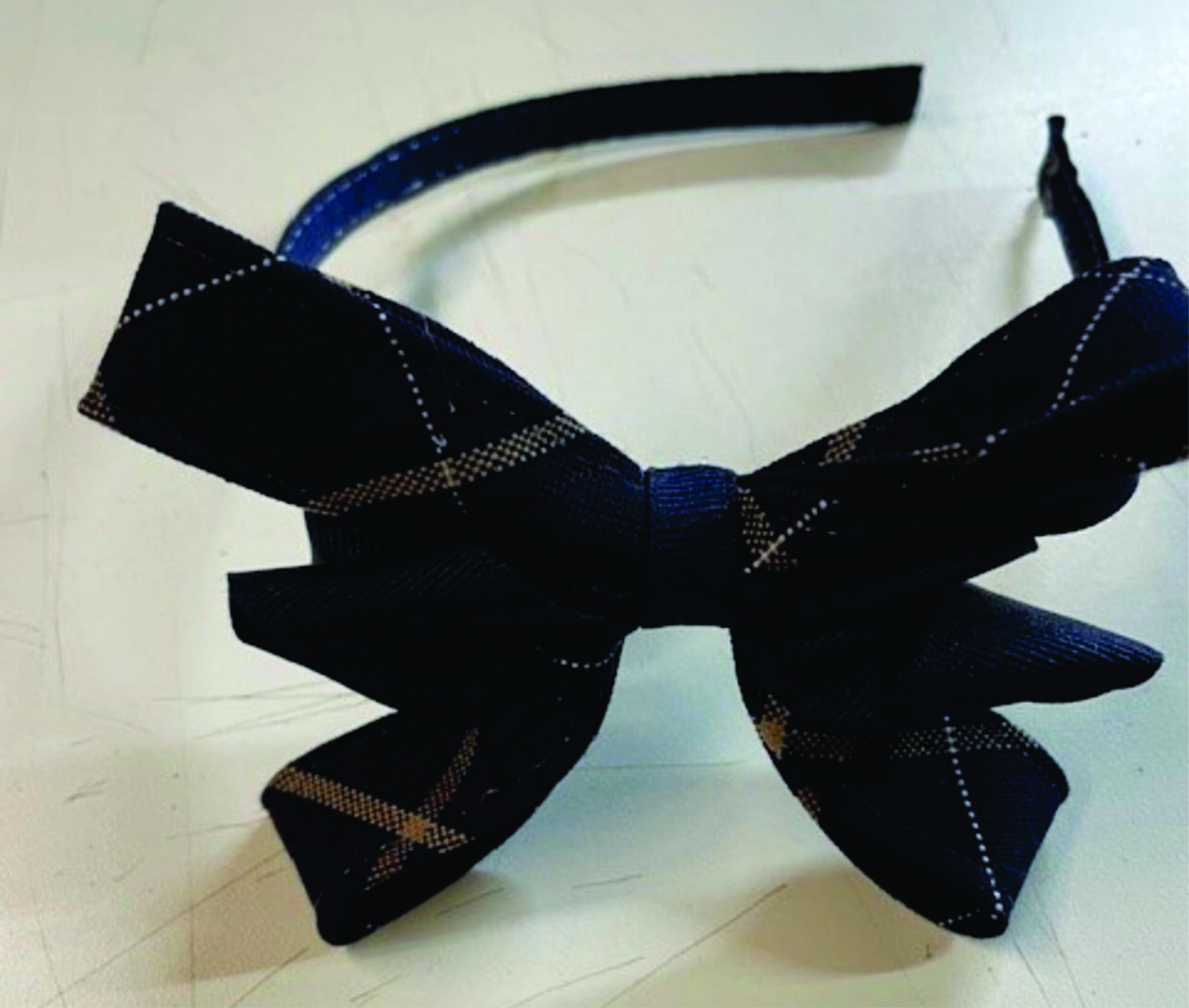 Navy blue bow on a black headband.