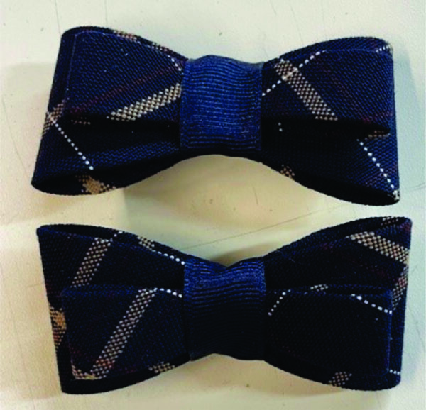 Two navy blue patterned bow ties.