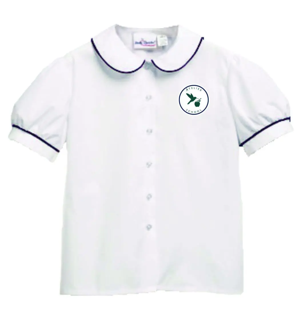 White blouse with embroidered logo on chest.